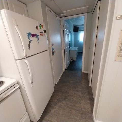 Hallway and refrigerator inside the condo
